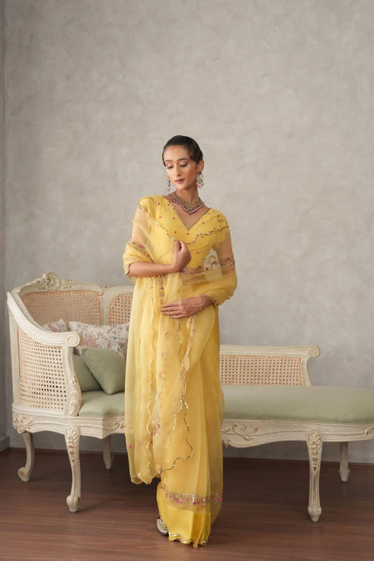 Buttercup yellow organza saree with scalloped edging and embroidered border - Sohni