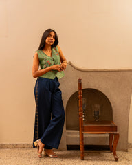 Forest green banarsi waistcoat with embroidered indigo pants