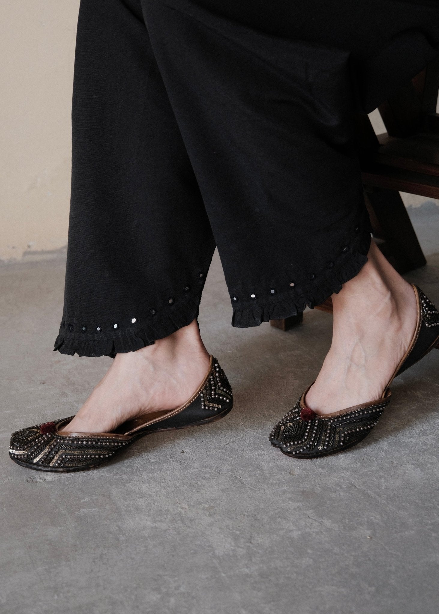 Black urmul cotton salwar with frill edged slanted opening and hand done mirror embroidery - Sohni