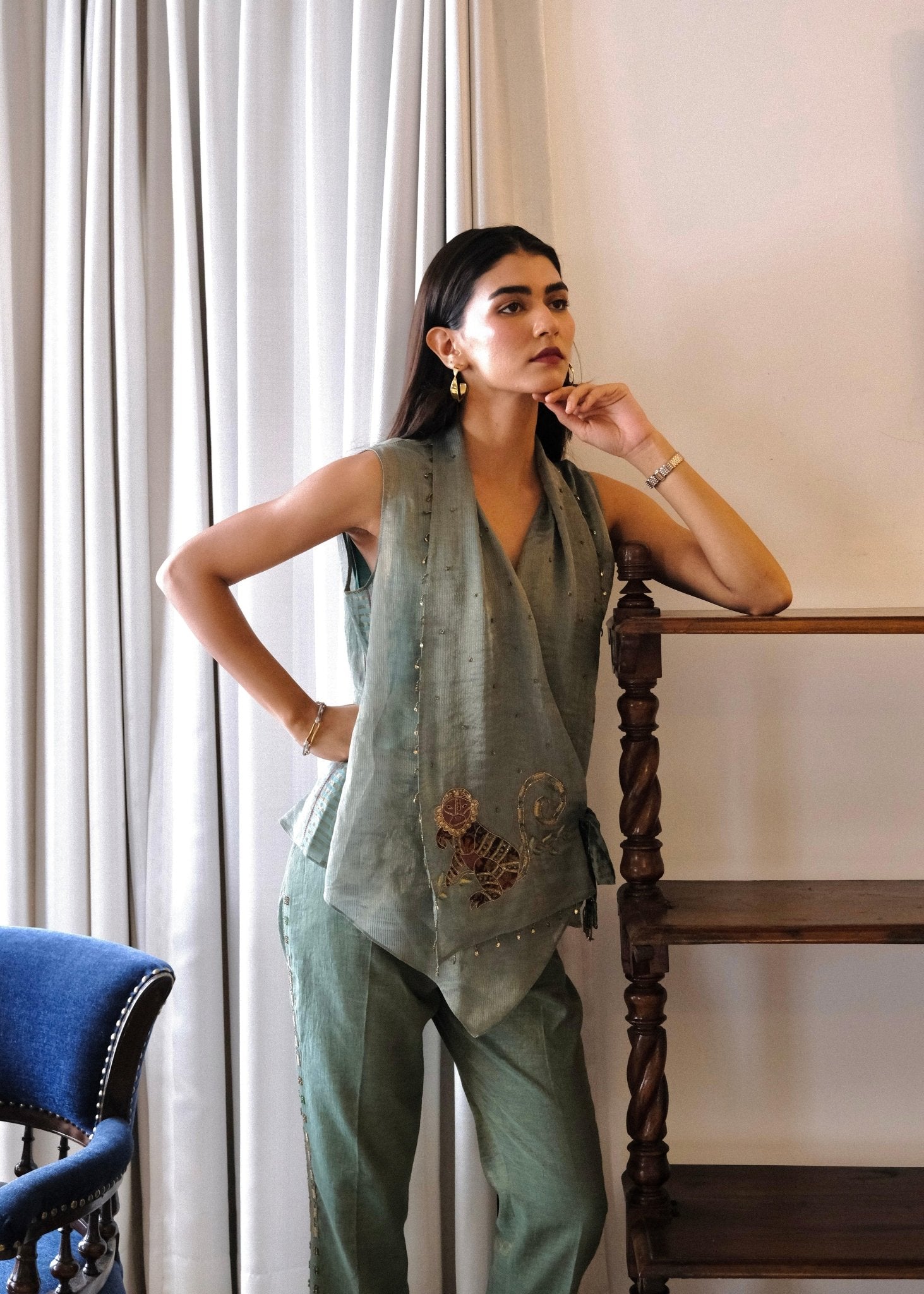 Eggshell striped tissue chanderi asymmetrical wrap top and tapered pants with monkey motif embroidery - Sohni