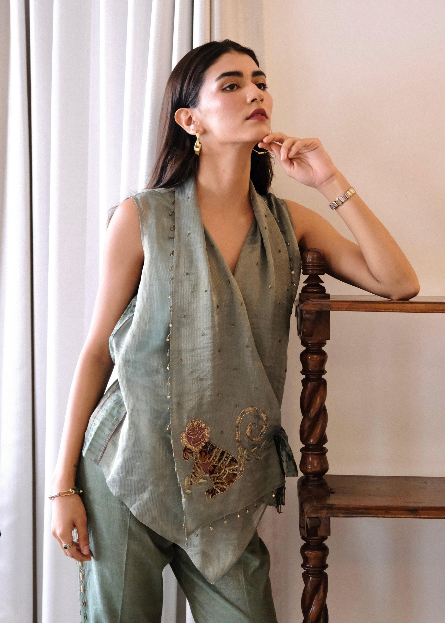 Eggshell striped tissue chanderi asymmetrical wrap top and tapered pants with monkey motif embroidery - Sohni