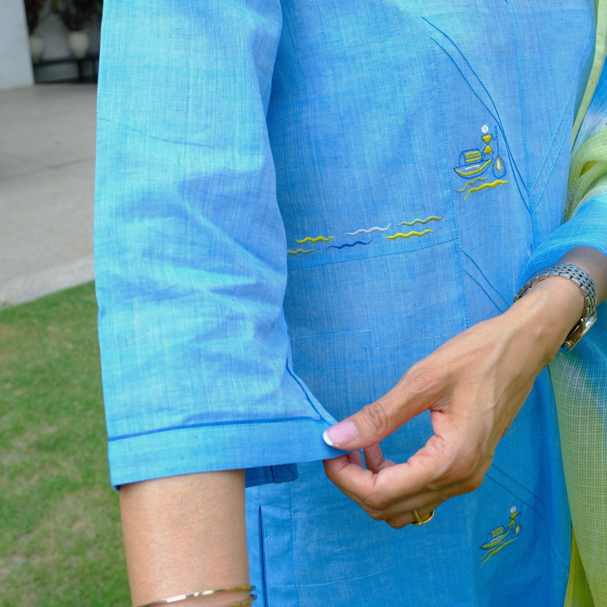 Sky blue mangalgiri pintucked kurta with Warli boat motif embroidery, white dobby salwar and lehriya kota doria dupatta - Sohni