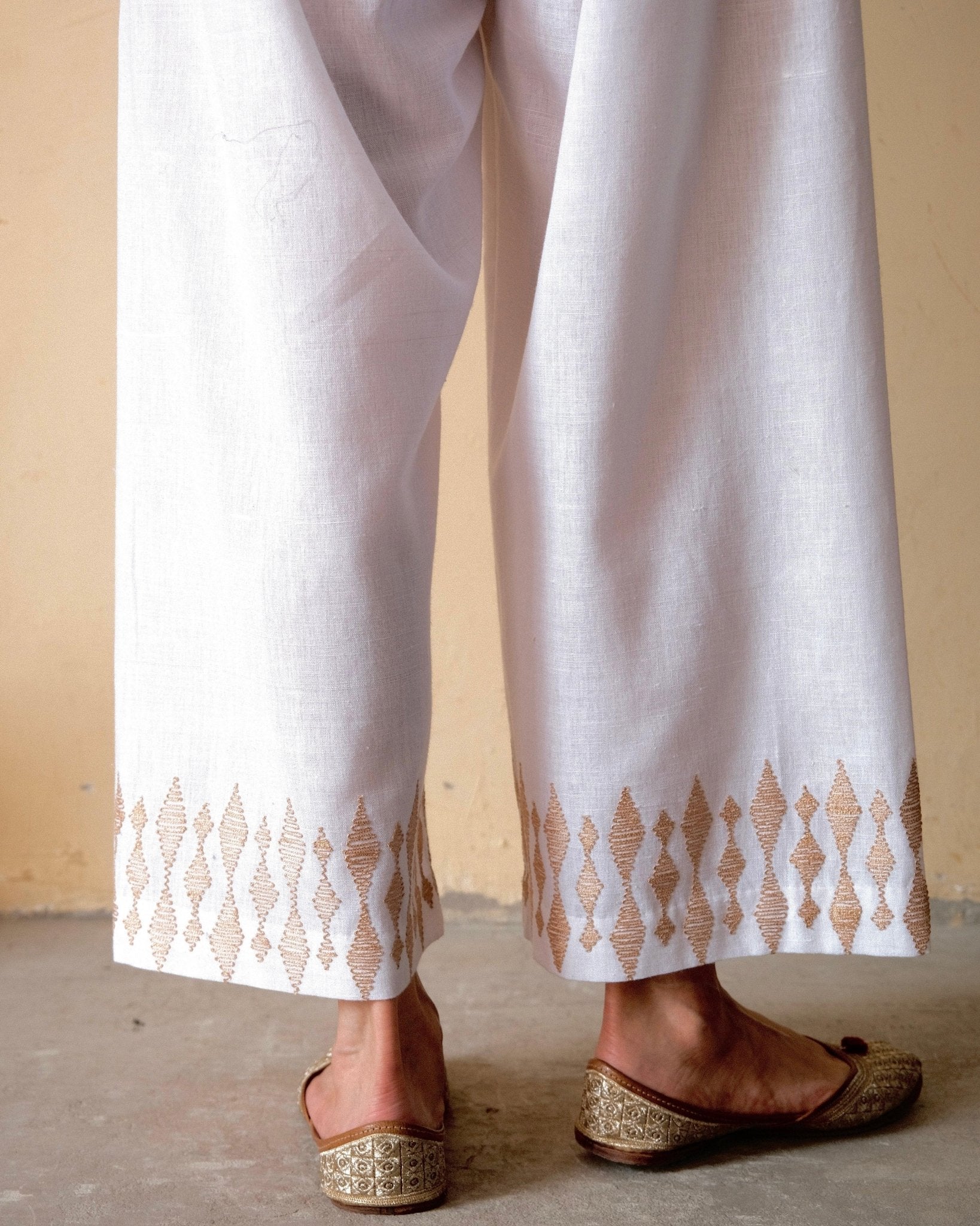 White handloom cotton palazzo pants with beige dori embroidery - Sohni