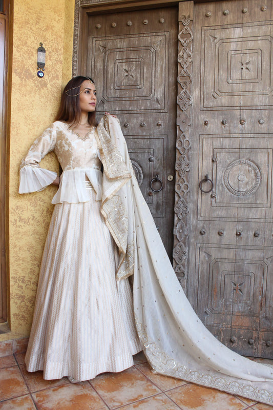 Kafoori ivory Banarasi cotton silk lehenga with peplum blouse and tissue chanderi embroidered dupatta - Sohni